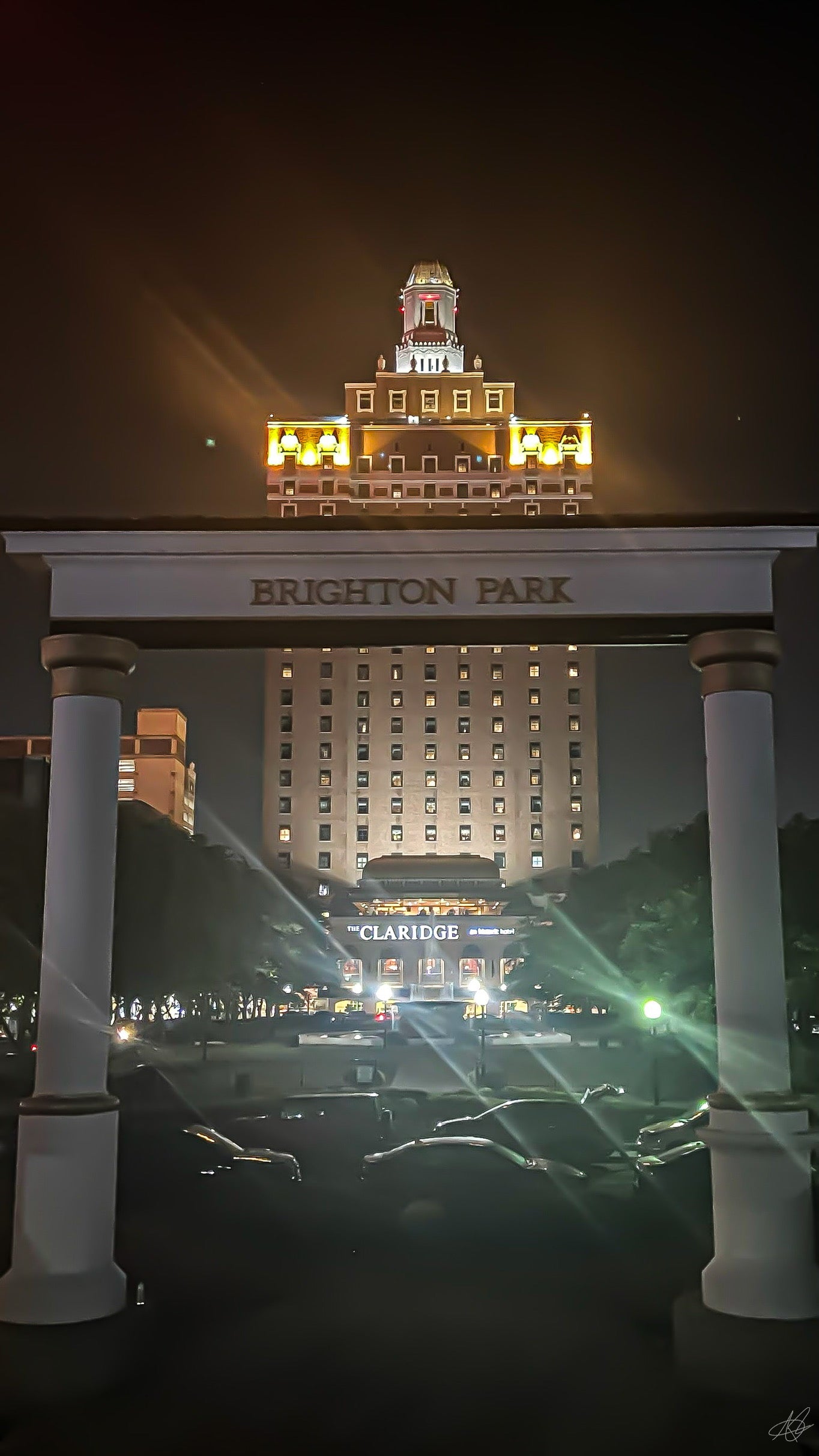 Front View of Brighton Park Entrance with The Claridge Hotel at Night