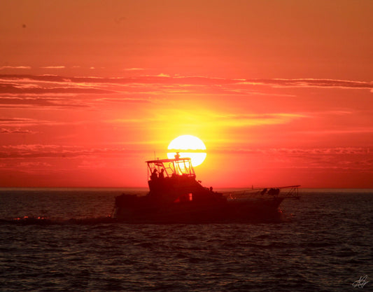 Beautiful Sunset with a Boat on the Water