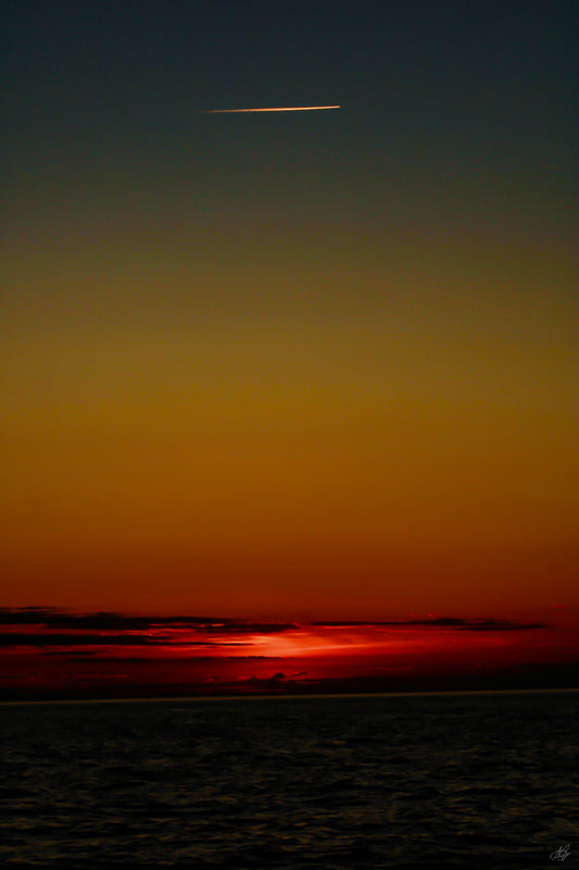 Portrait Sunset Over Ocean with Comet and Beautiful Sky Hues