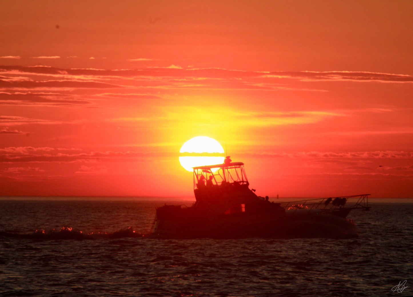 Sunset on the Back of a Boat in the Waters
